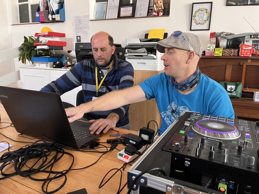 Two Gig Buddies using laptop and DJ equipment